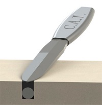 Grey Albion C.A.T. Spatula in use on a tan surface