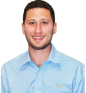 Charlie Gerstman from Harvey Gerstman Associtates - Smiling & Wearing a Blue Button Down Shirt