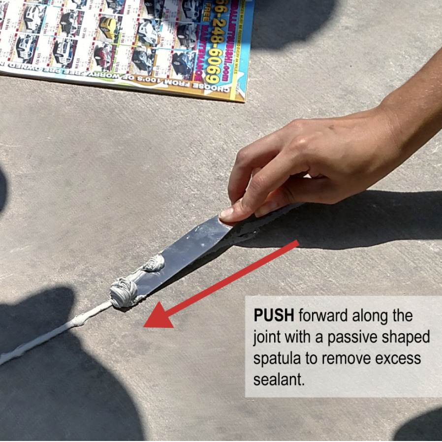Instructional image on how to push a spatula to remove excess sealant